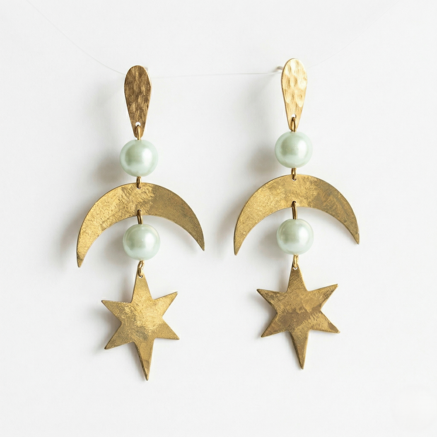 Mozaika Collective Star and Moon Earrings flat lay, solid brass artisan jewellery Berlin