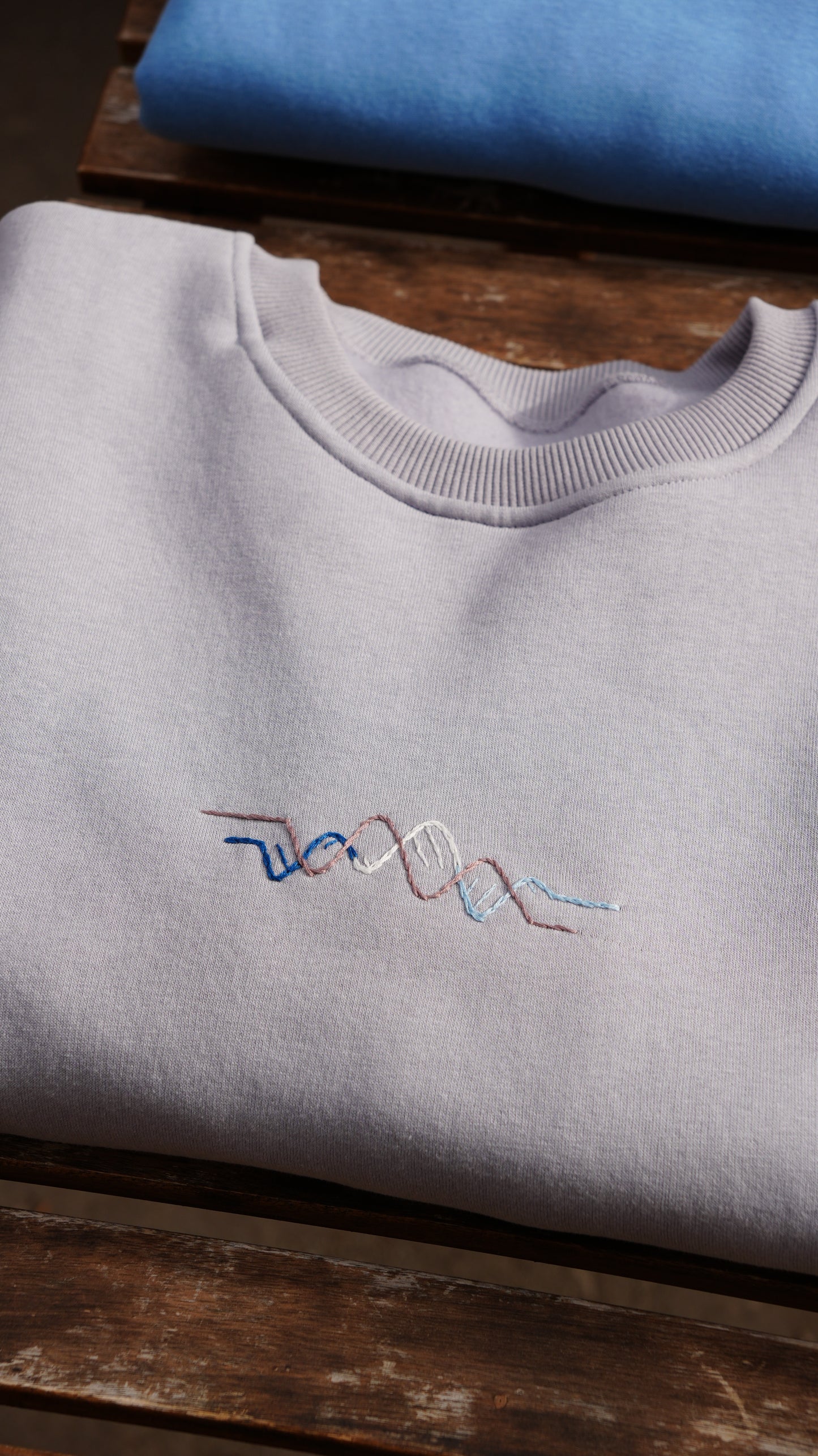 Model wearing Momeni Vivaldi Winter Grey Sweatshirt, unique hand-embroidered artisan knitwear
