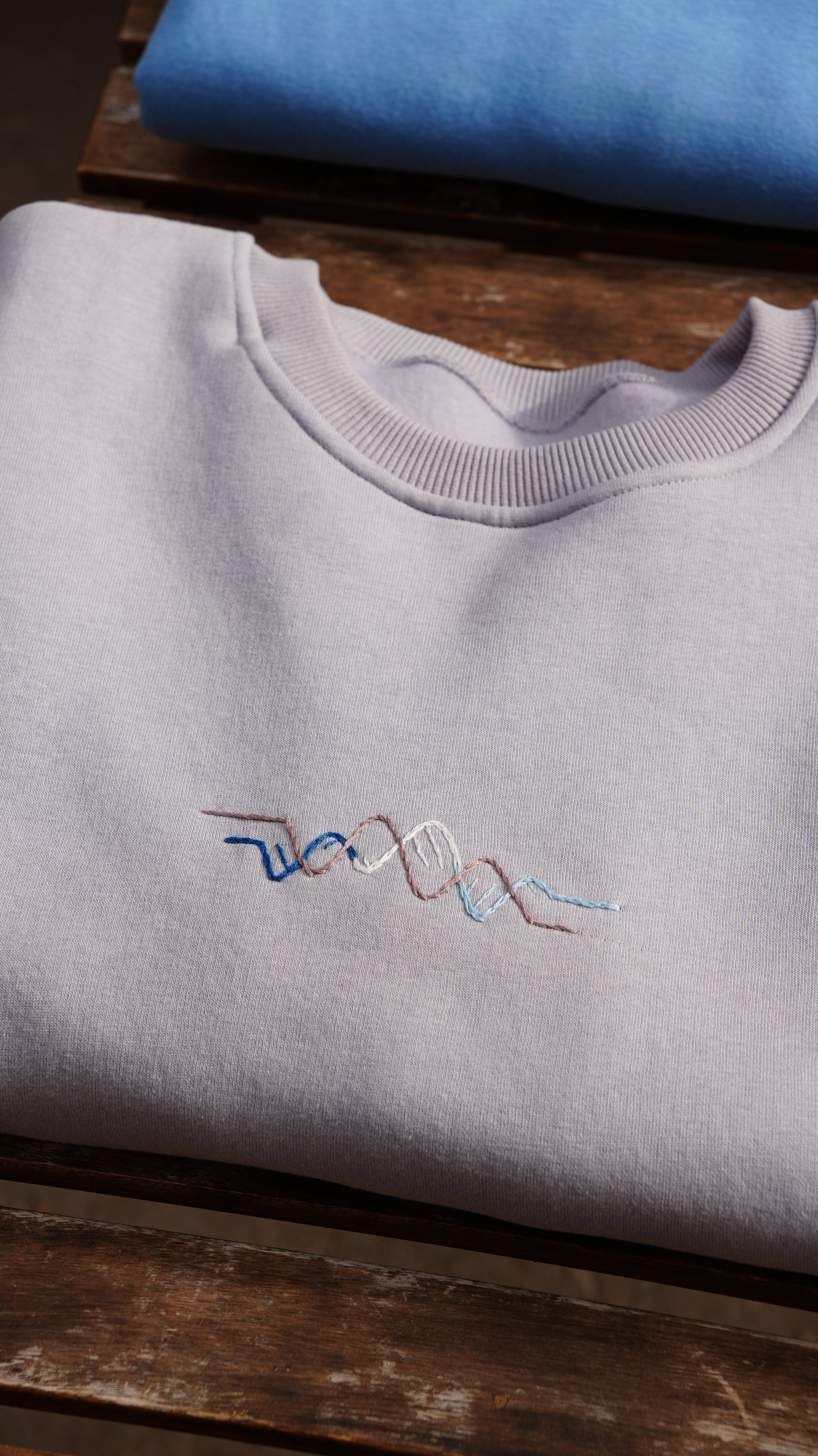Model wearing Momeni Vivaldi Winter Grey Sweatshirt, unique hand-embroidered artisan knitwear