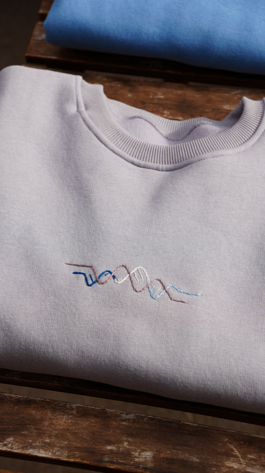 Model wearing Momeni Vivaldi Winter Grey Sweatshirt, unique hand-embroidered artisan knitwear