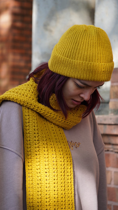 Model wearing Mozaika Collective Mustard Yellow Cozy Knits Scarf, warm handmade artisan scarf