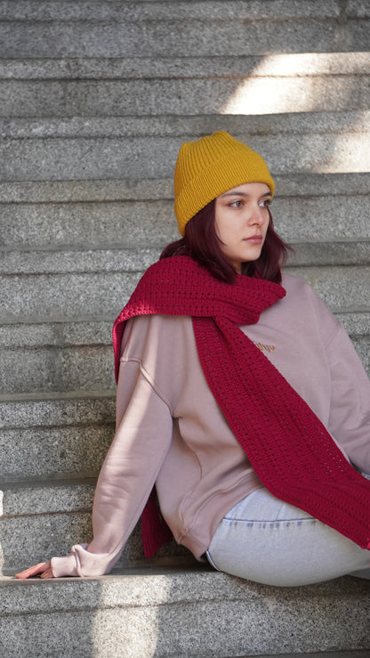 Model wearing Mozaika Collective Mulberry Burgundy Cozy Knits Scarf, warm handmade artisan scarf