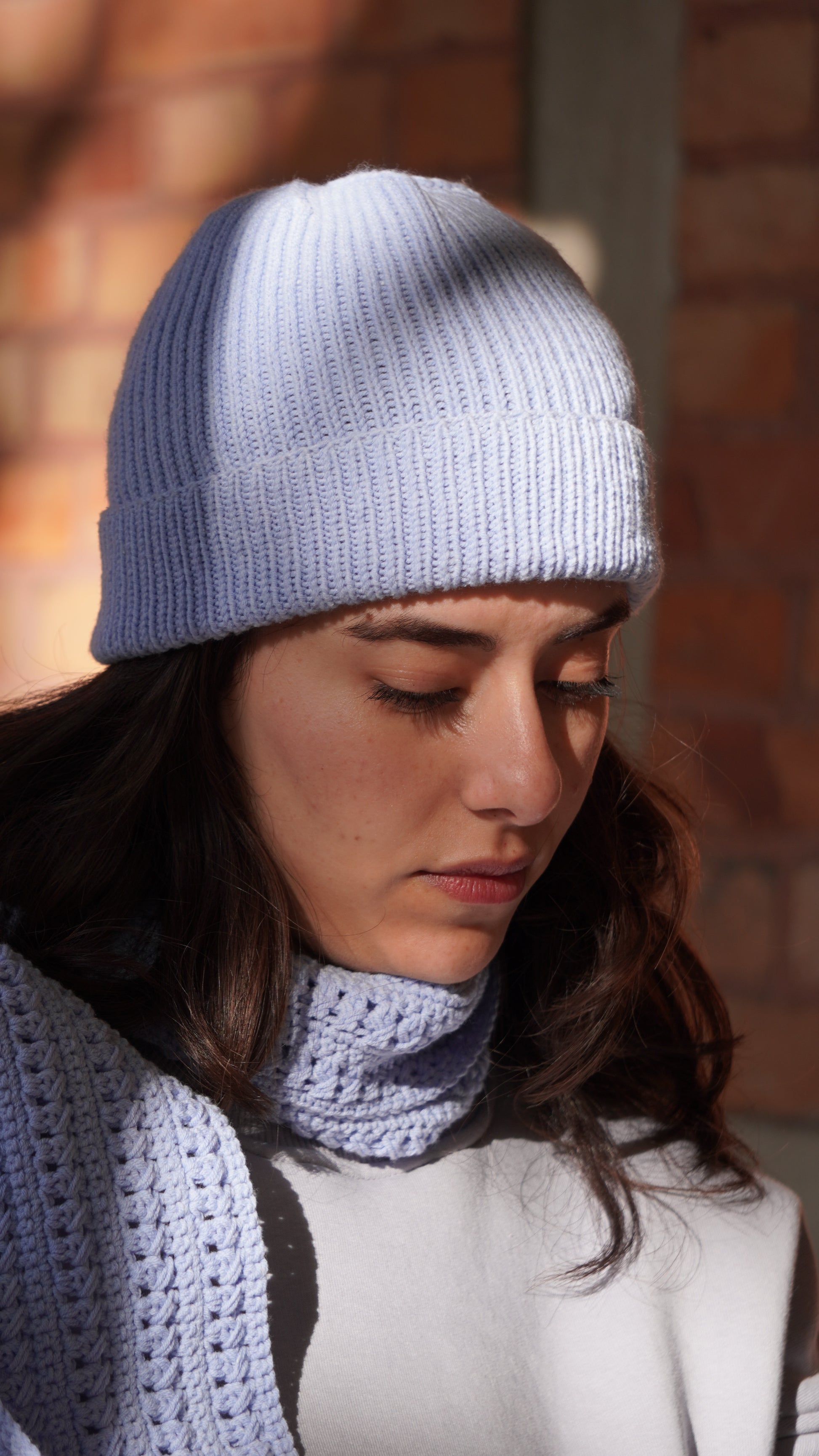 Model wearing Mozaika Collective Sky Blue Cozy Knits Beanie, soft breathable everyday beanie