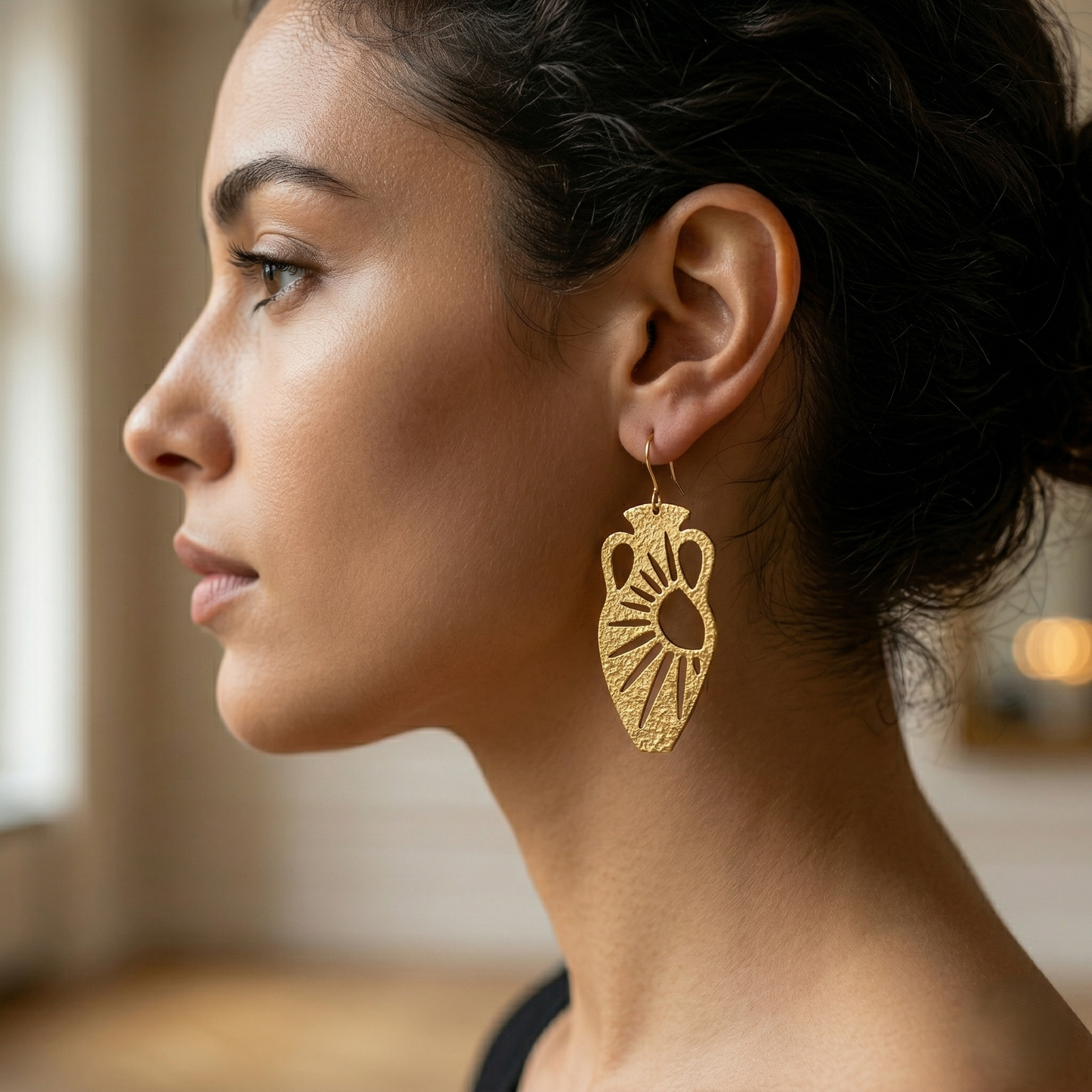 Model wearing Mozaika Collective Sun and Moon Vase Earrings, handmade solid brass statement earrings