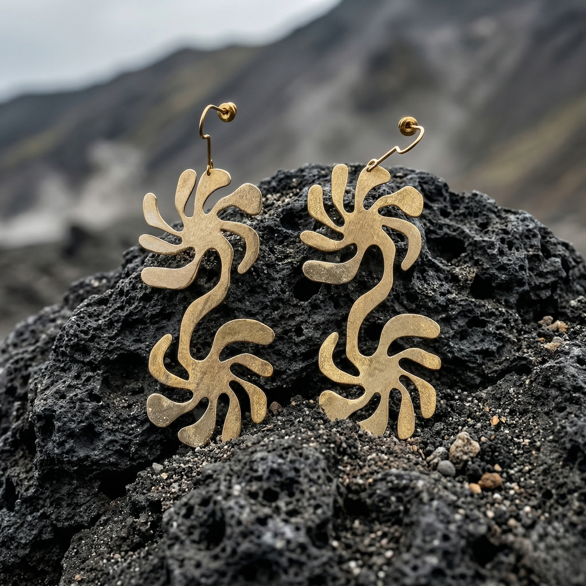 Mozaika Collective Solaris Earrings close-up showing hand-formed solid brass double swirl detail
