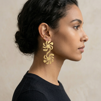 Model wearing Mozaika Collective Solaris Brass Earrings, handmade solar flare inspired jewellery
