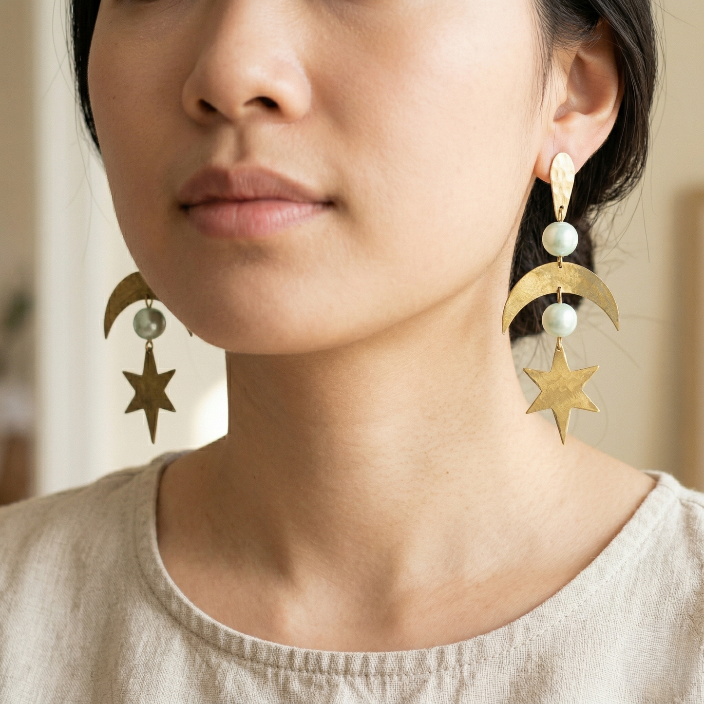 Model wearing Mozaika Collective Star and Moon Earrings, handmade solid brass statement jewellery
