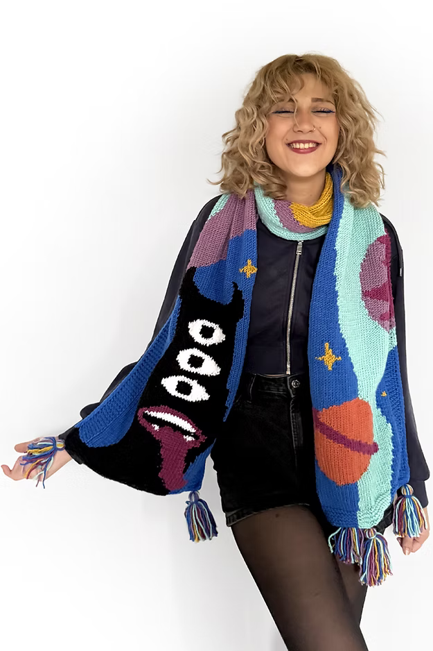 Model wearing Zone Design Alien Scarf, unique handmade artisan scarf with alien motif